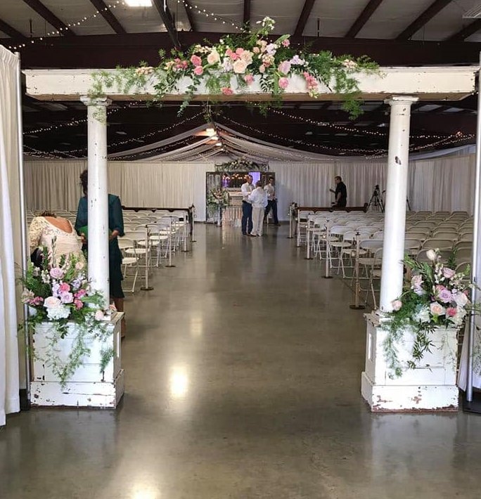 white vintage arch and pink roses for wedding event